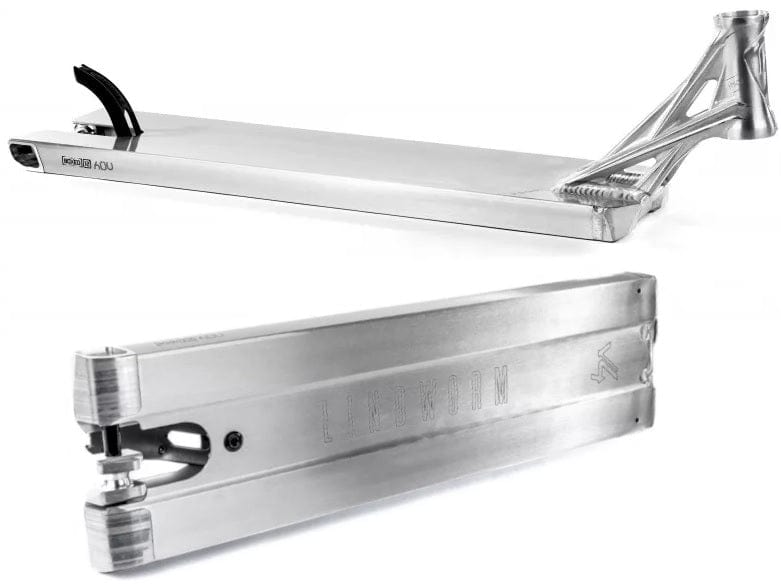 The sleek Ethic DTC Lindworm V4 Raw Silver Stunt Scooter Deck in a close-up highlights its lightweight design. This 5.9" x 21.25" deck boasts a brushed metal finish with intricate cutout details at the rear, while the Ethic brand name and logo are subtly embossed on the side.