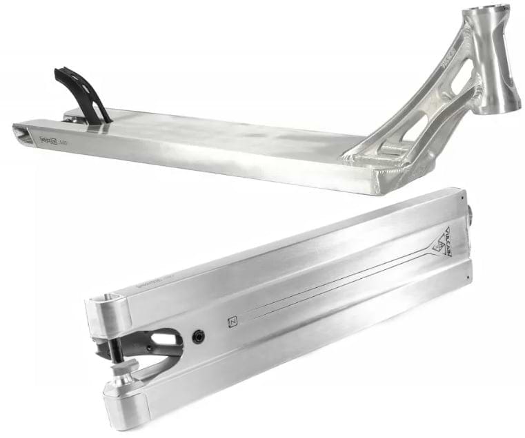 Two silver scooter decks by Ethic are displayed, one from the side and the other from the bottom. The Ethic DTC Vulcain V2, with its boxed 12 STD design, showcases angular features and cutouts near the neck in the side view, while smooth lines and wheel mounts are prominent in the bottom view, highlighting its suitability for any stunt scooter setup.