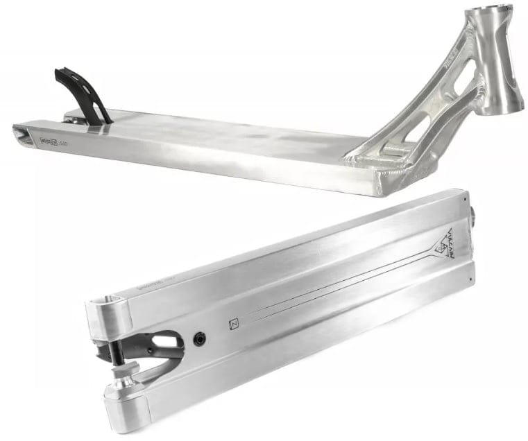 Two silver scooter decks by Ethic are displayed, one from the side and the other from the bottom. The Ethic DTC Vulcain V2, with its boxed 12 STD design, showcases angular features and cutouts near the neck in the side view, while smooth lines and wheel mounts are prominent in the bottom view, highlighting its suitability for any stunt scooter setup.