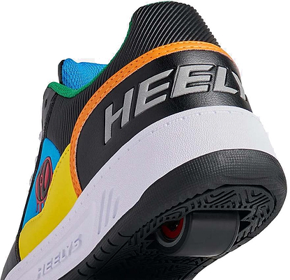 A close-up of the back and side of Heelys Rezerve Low Boys Shoes by Heelys, in black with red, cyan, and yellow accents, showing the heel wheel and "HEELY" branding on the heel.