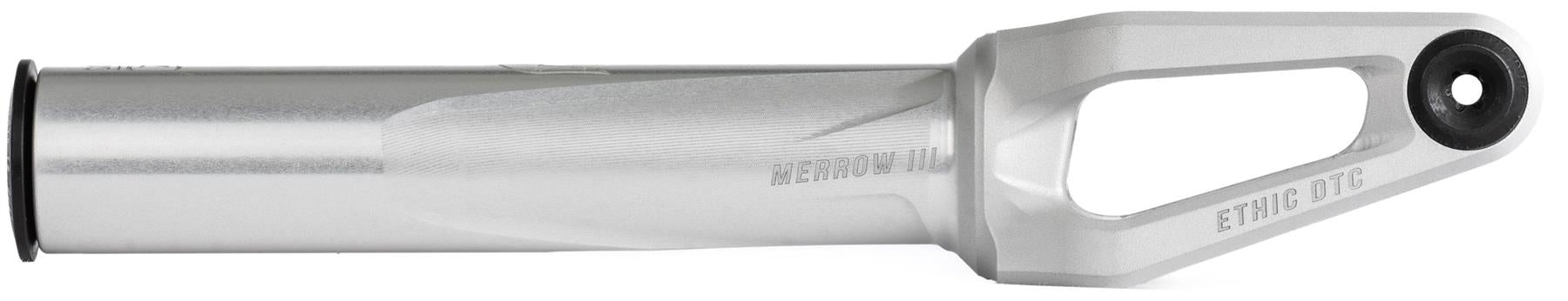 The Ethic DTC Merrow V3 8/12STD SCS Stunt Scooter Fork in raw features a silver cylindrical body, a triangular cutout near the top, and "MERROW V2" and "ETHIC DTC" engraved. Compatible with 12STD forks or as an upgrade to Merrow V3.