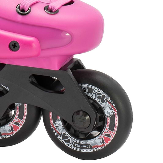 Close-up of the FR Skates Junior Adjustable Inline Skates - Pink, showcasing extruded aluminum X-Series frames and black wheels. The decorative white and red patterns feature card suits like hearts and spades. The pink boot, ideal for freeriders, is partially visible with pink laces.