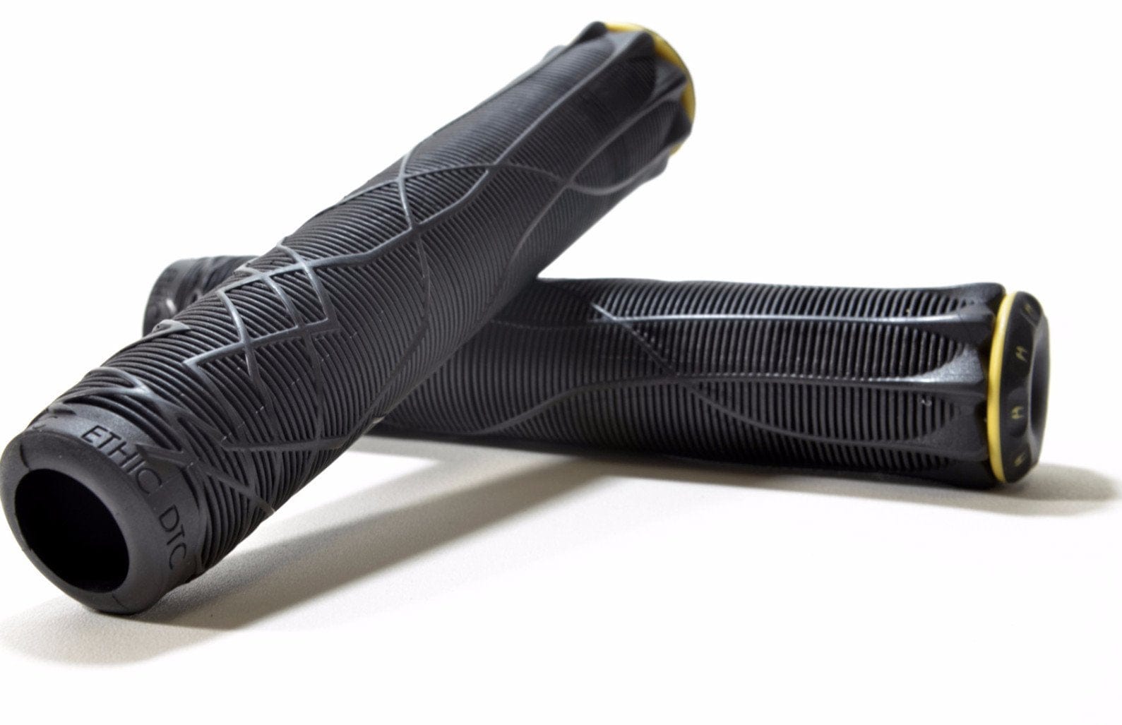 Two Ethic black stunt scooter grips, each measuring 170mm and made from durable thermoplastic rubber, showcase textured patterns with yellow accents. They are arranged overlapping on a white background.