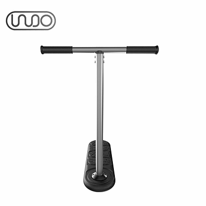 The INDO 670mm Indoor Trampoline Stunt Scooter - Black is a modern, minimalist kick scooter ideal for stunt scootering. It features a T-shaped handlebar and black deck, with matching black handle grips and deck top. The sleek metallic frame adds an extra touch of style, while the INDO brand logo is prominently displayed in the upper left corner on a white background.