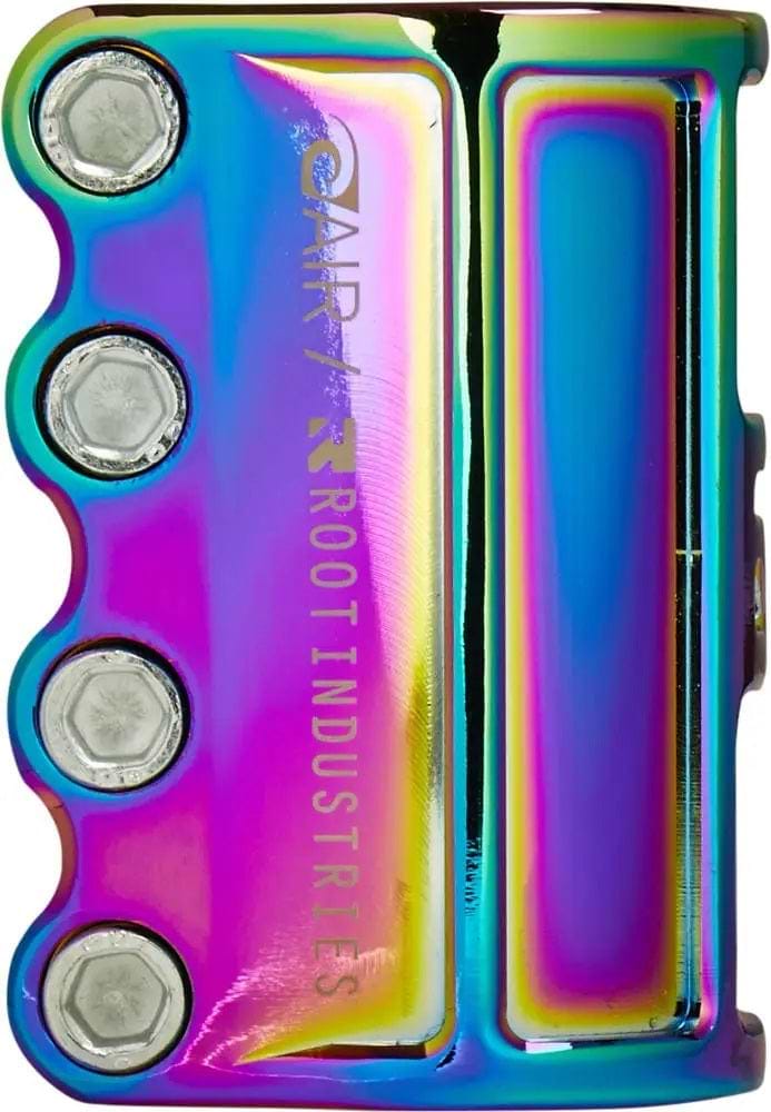 The Root Industries AIR 4 Bolt SCS Stunt Scooter Clamp in Rocket Fuel Neochrome features a lightweight and vibrant iridescent metal design. With the "Root Industries Air SCS Clamp" text etched on its side, it serves as an ideal scooter clamp, reflecting a breathtaking array of colors such as blue, purple, and yellow.