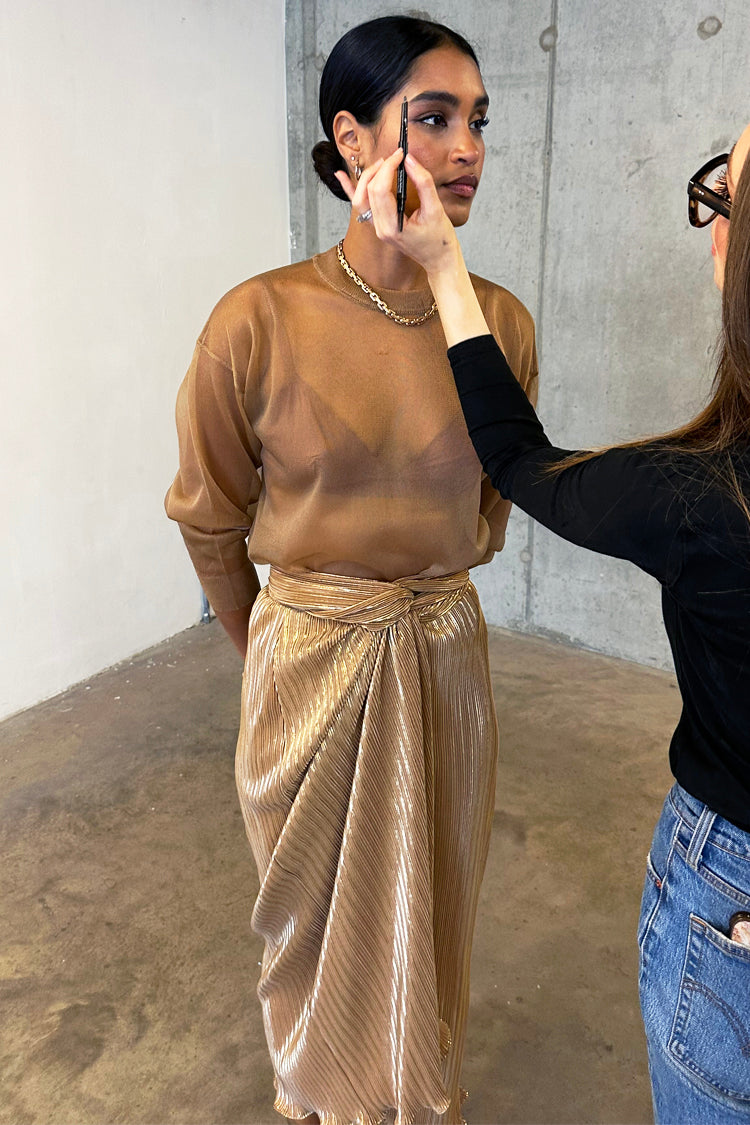 Model wearing Gold Plisse Jaspre Skirt