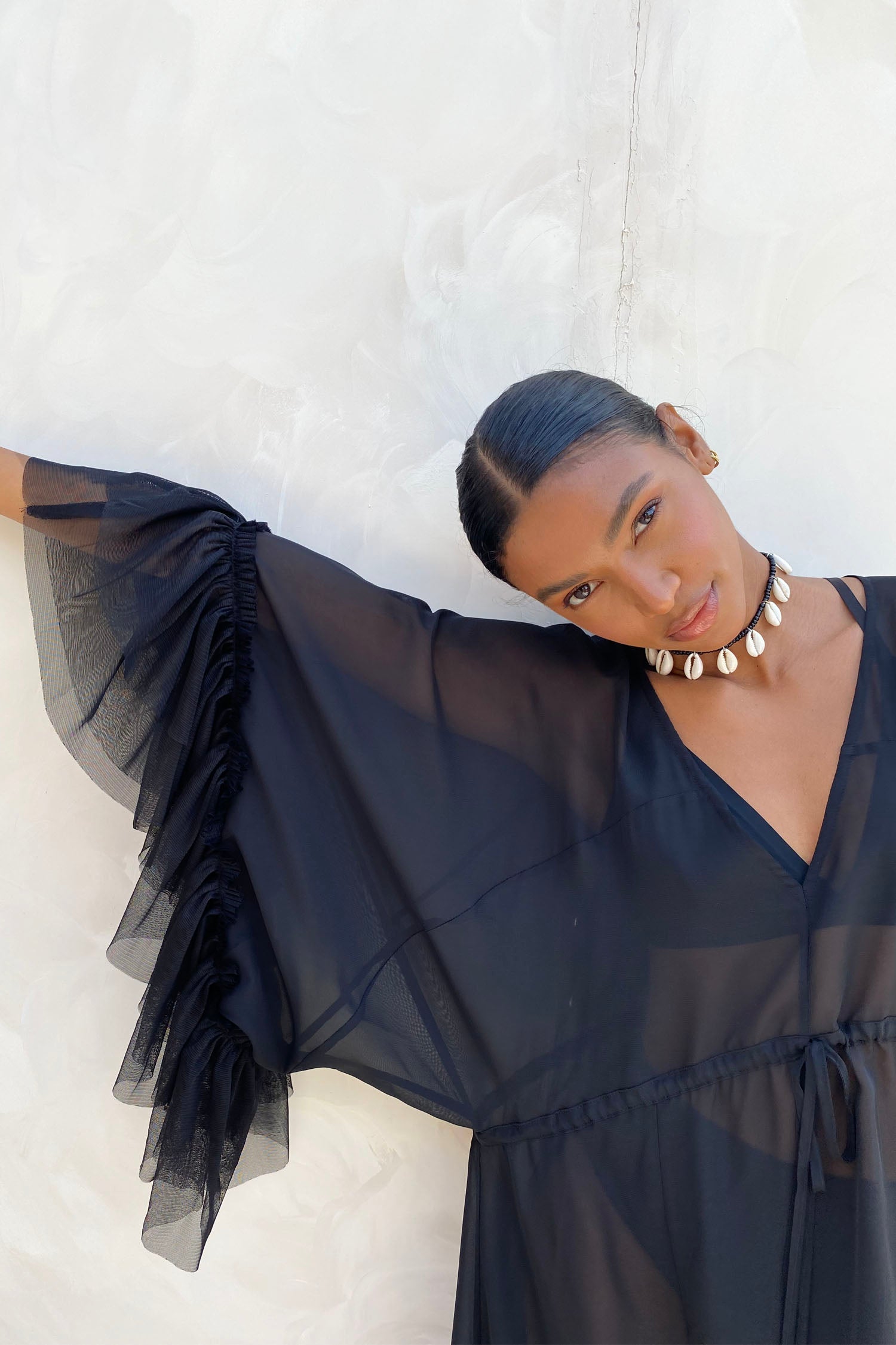 Model wearing Black Sloane Dress standing facing the camera close up