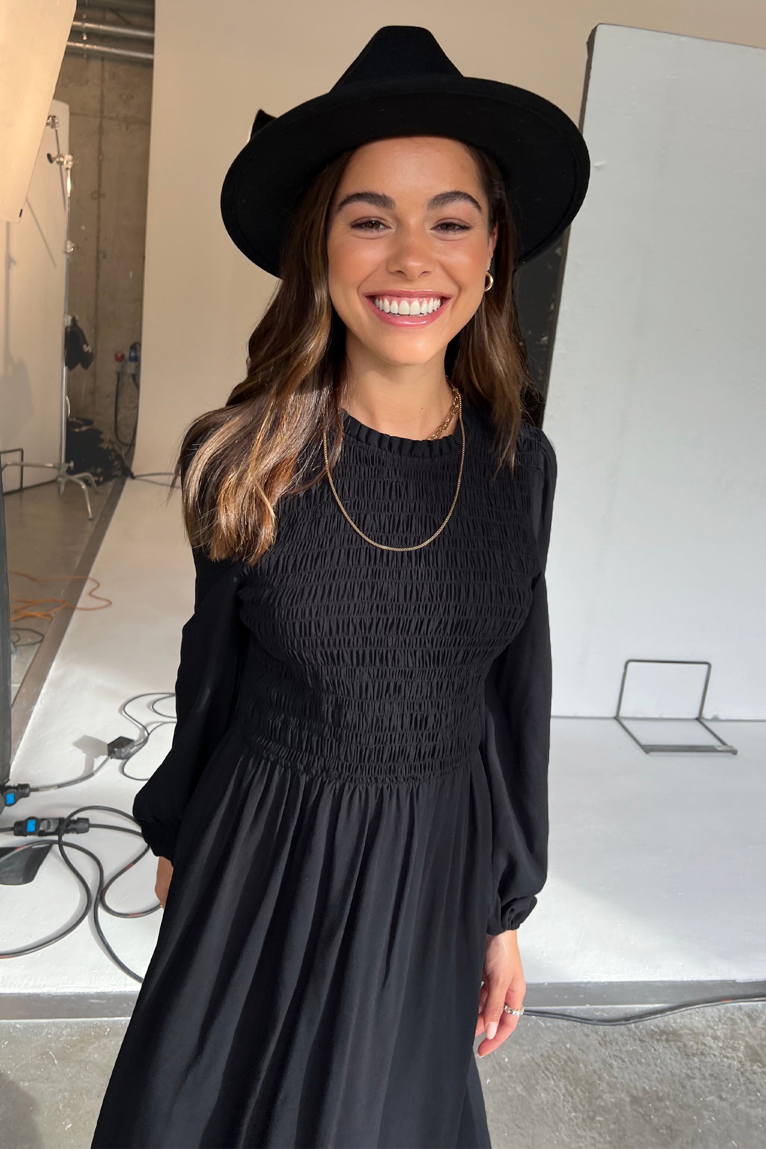 Model wearing Black Swedish Dress standing facing the camera