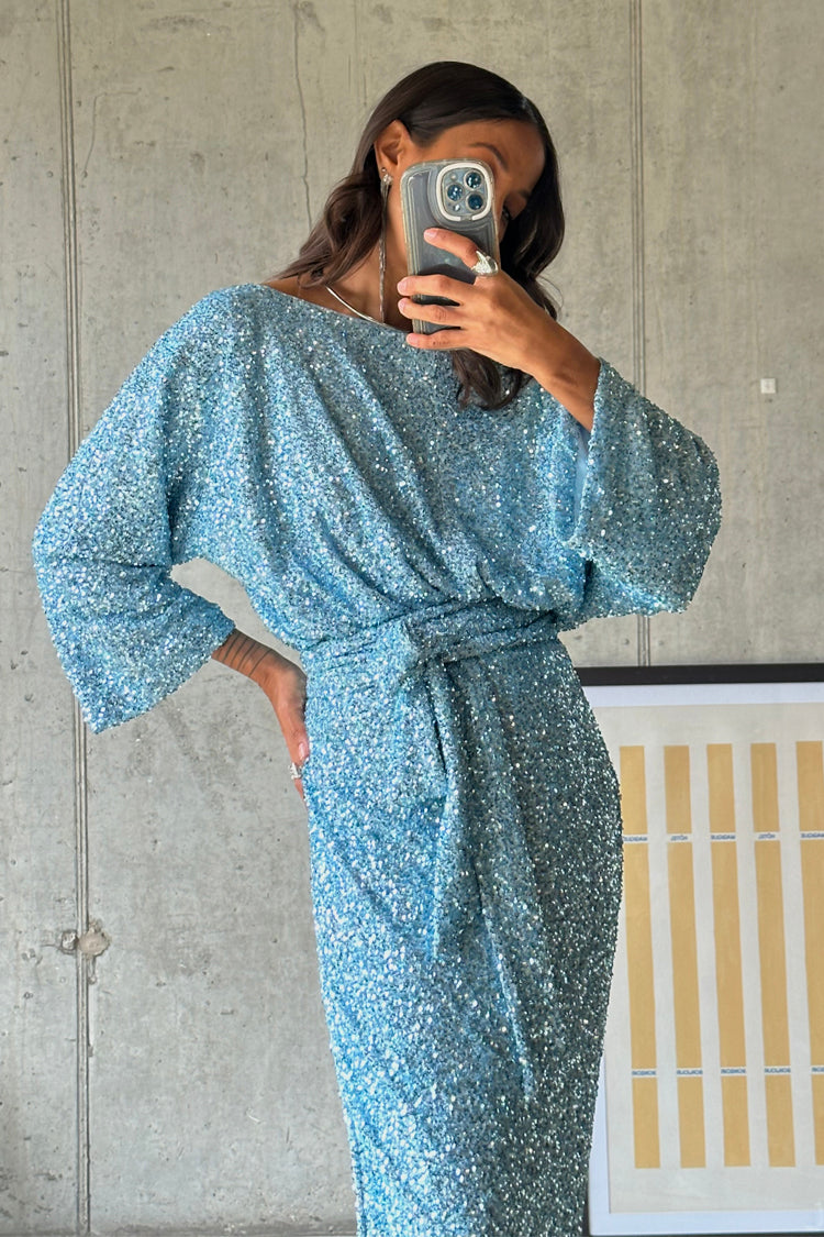 caption_Model wears Blue Sequin Tilly Top in UK size 10/ US 6