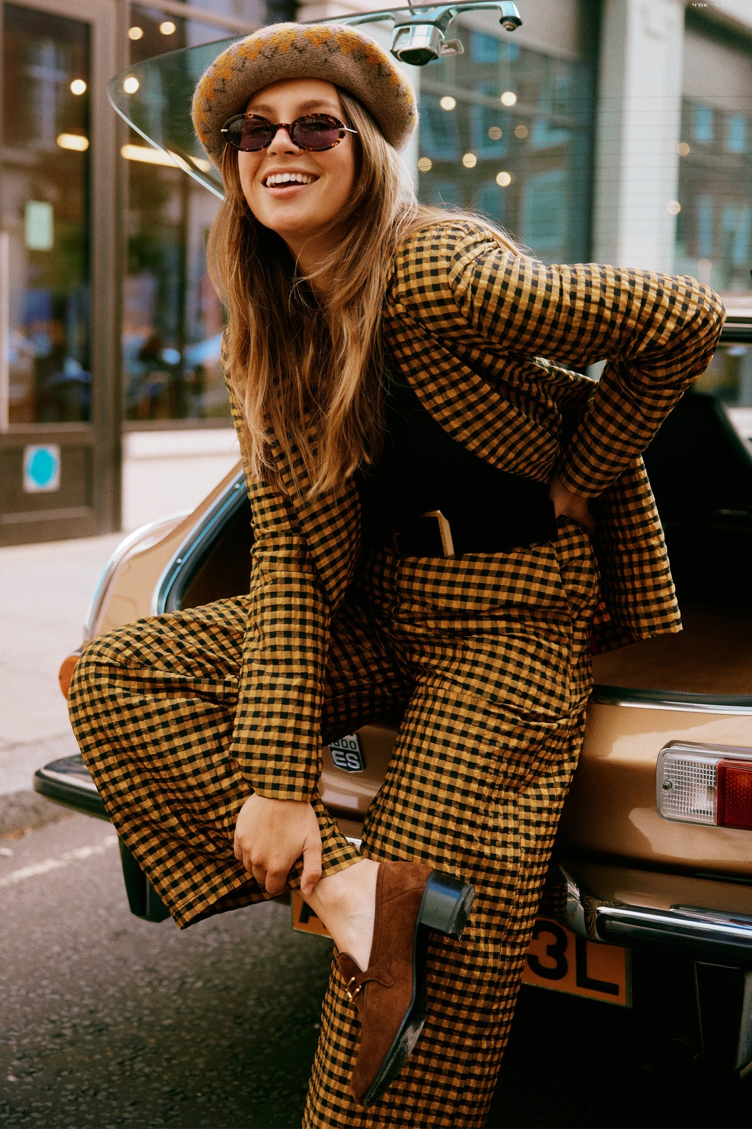 Model wearing Check Blazer sitting facing the camera 
