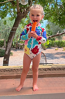Thumbnail for Model wearing Kids Dotty Swimsuit standing facing the camera