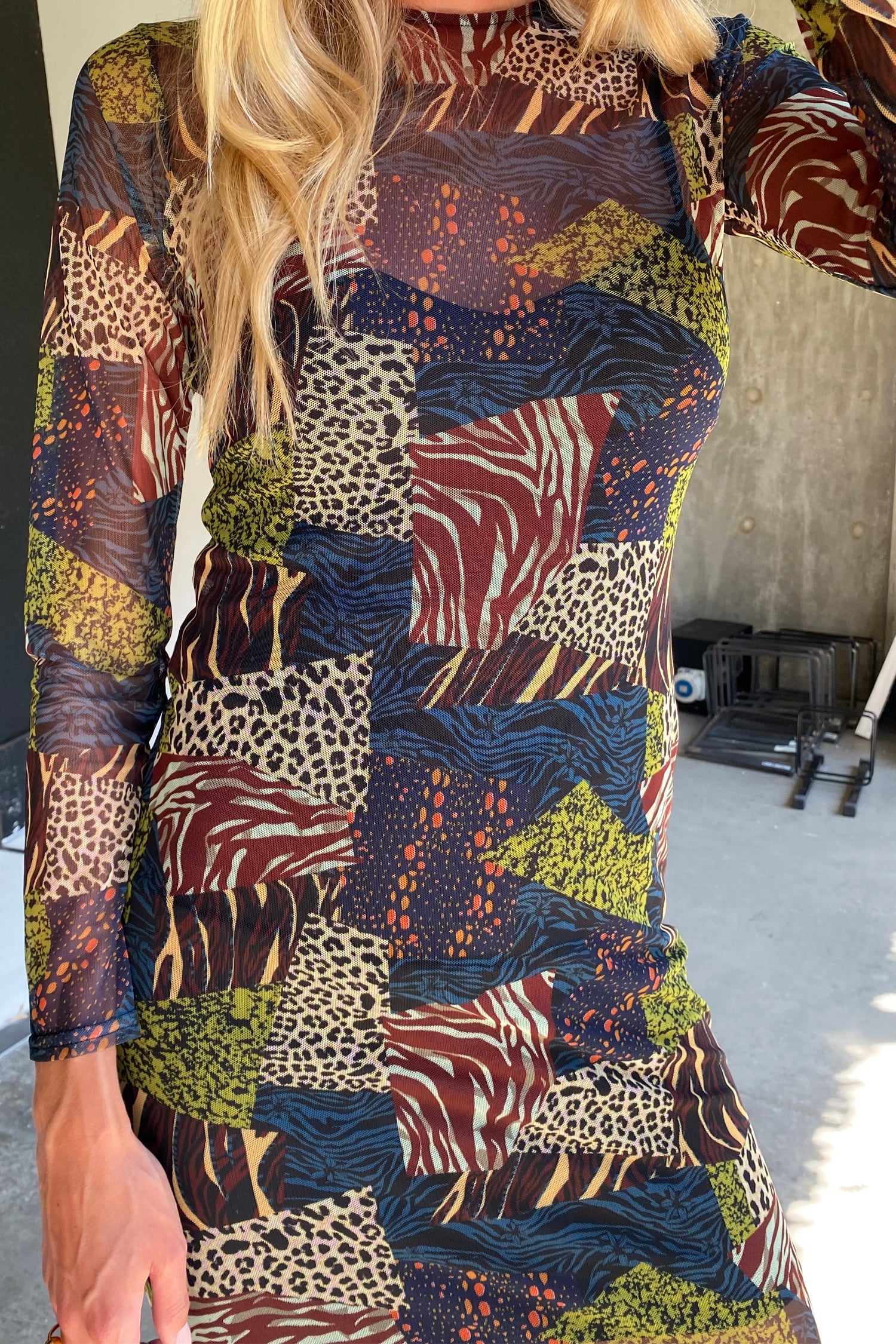 Model wearing Fiona Animal Mesh Dress standing facing the camera close up
