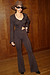 Model wearing Bronze Sparkle Trousers standing facing the camera