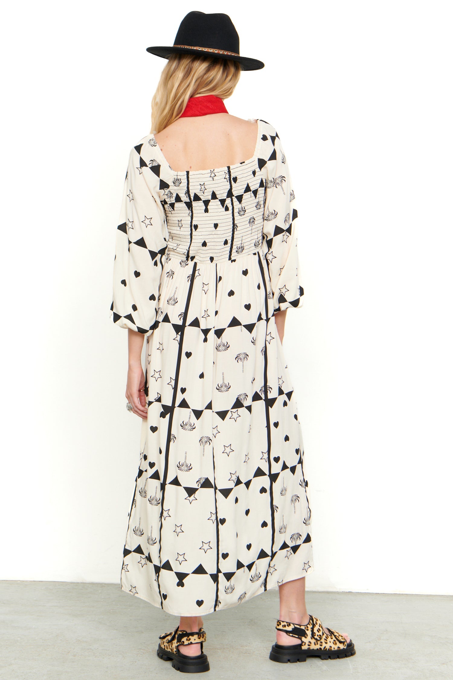 Model wearing Mono Palm Jasmine Dress standing facing away from the camera 
