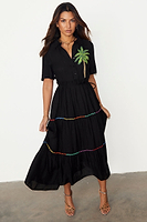 Thumbnail for  caption_Model wears Black Palm Immy Dress in UK size 10/ US 6