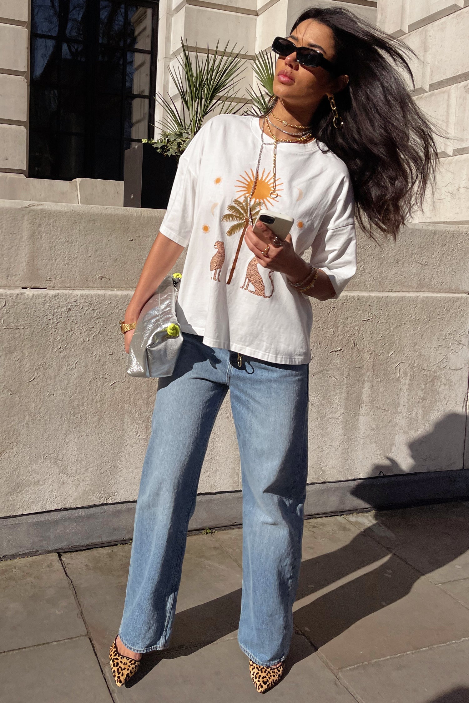 Model wearing White Running Wild T-Shirt standing facing the camera