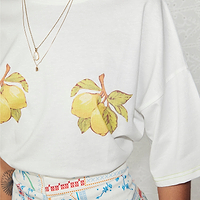 Thumbnail for caption_Model wears Lemon Boob T-shirt in UK size 10/ US 6