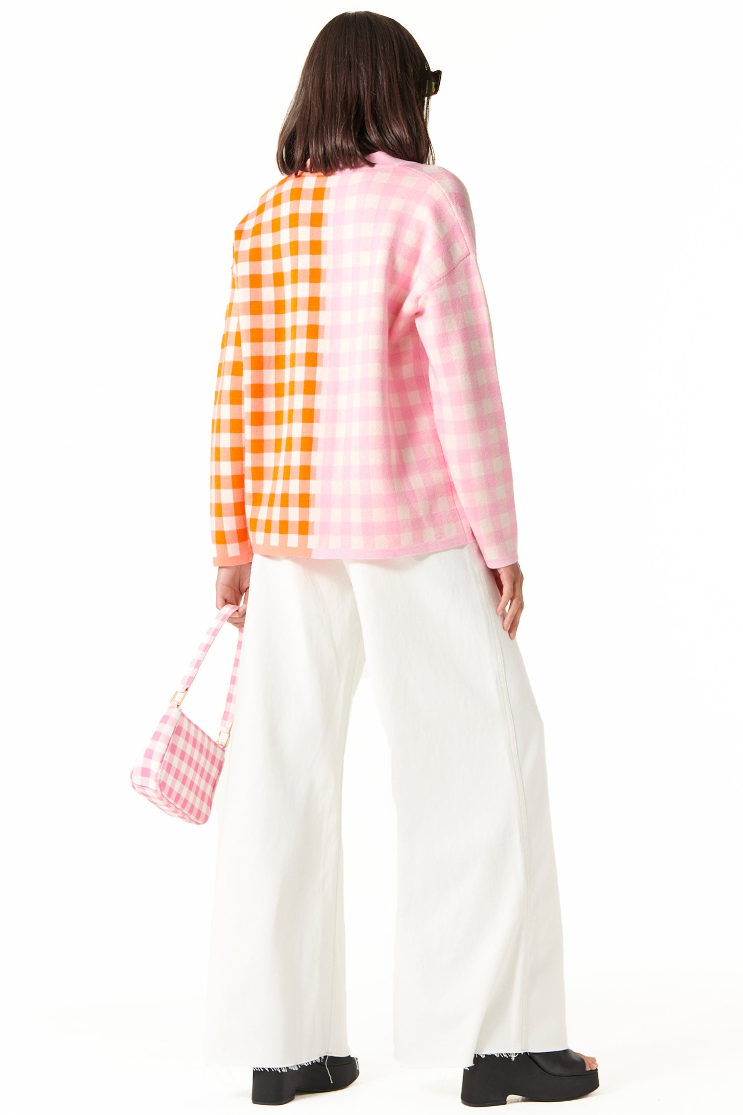 Model wearing Pink Check Sophie Cardi standing facing away from  the camera