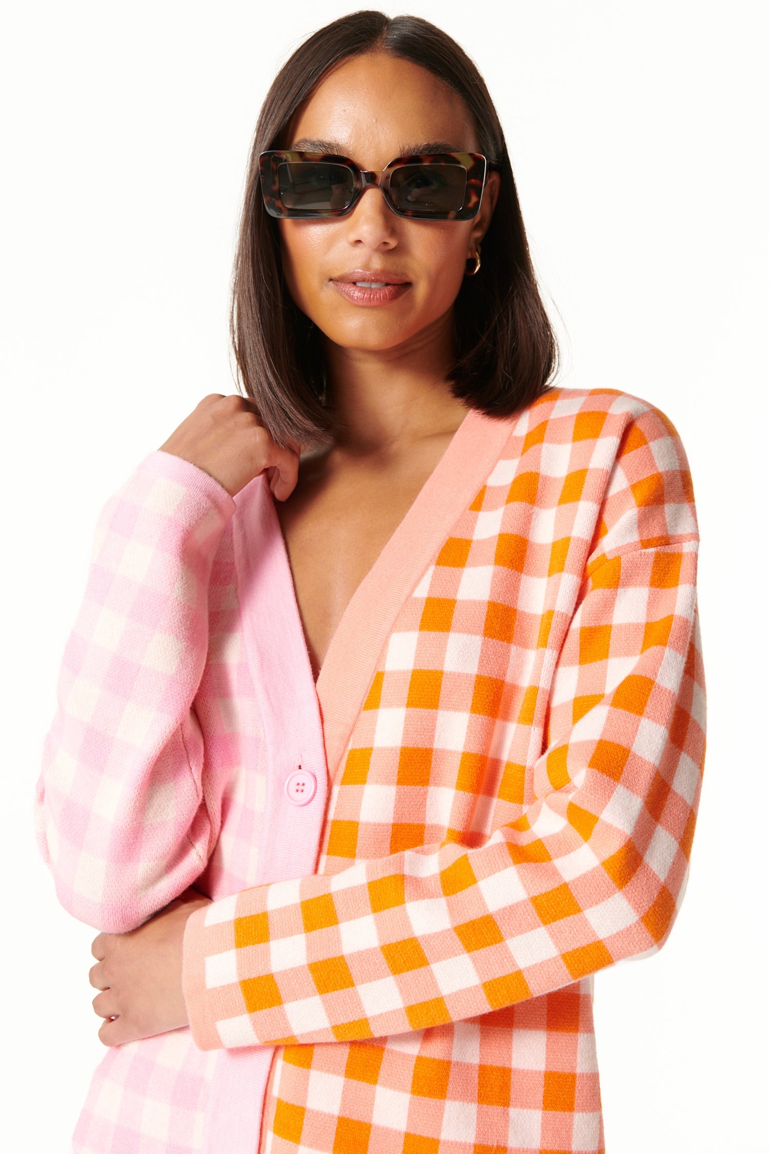 Model wearing Pink Check Sophie Cardi standing facing the camera close up