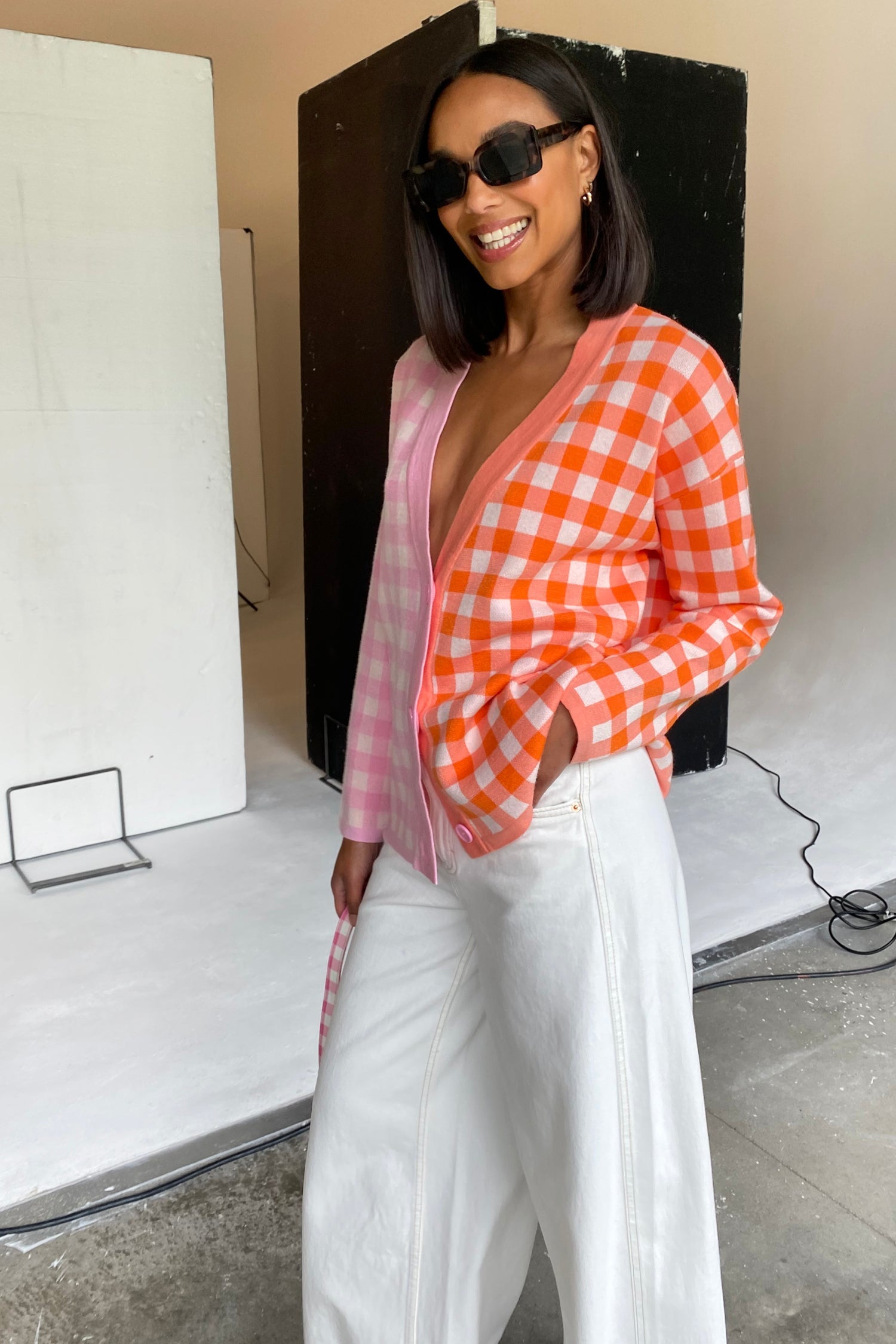 Model wearing Pink Check Sophie Cardi standing facing the camera