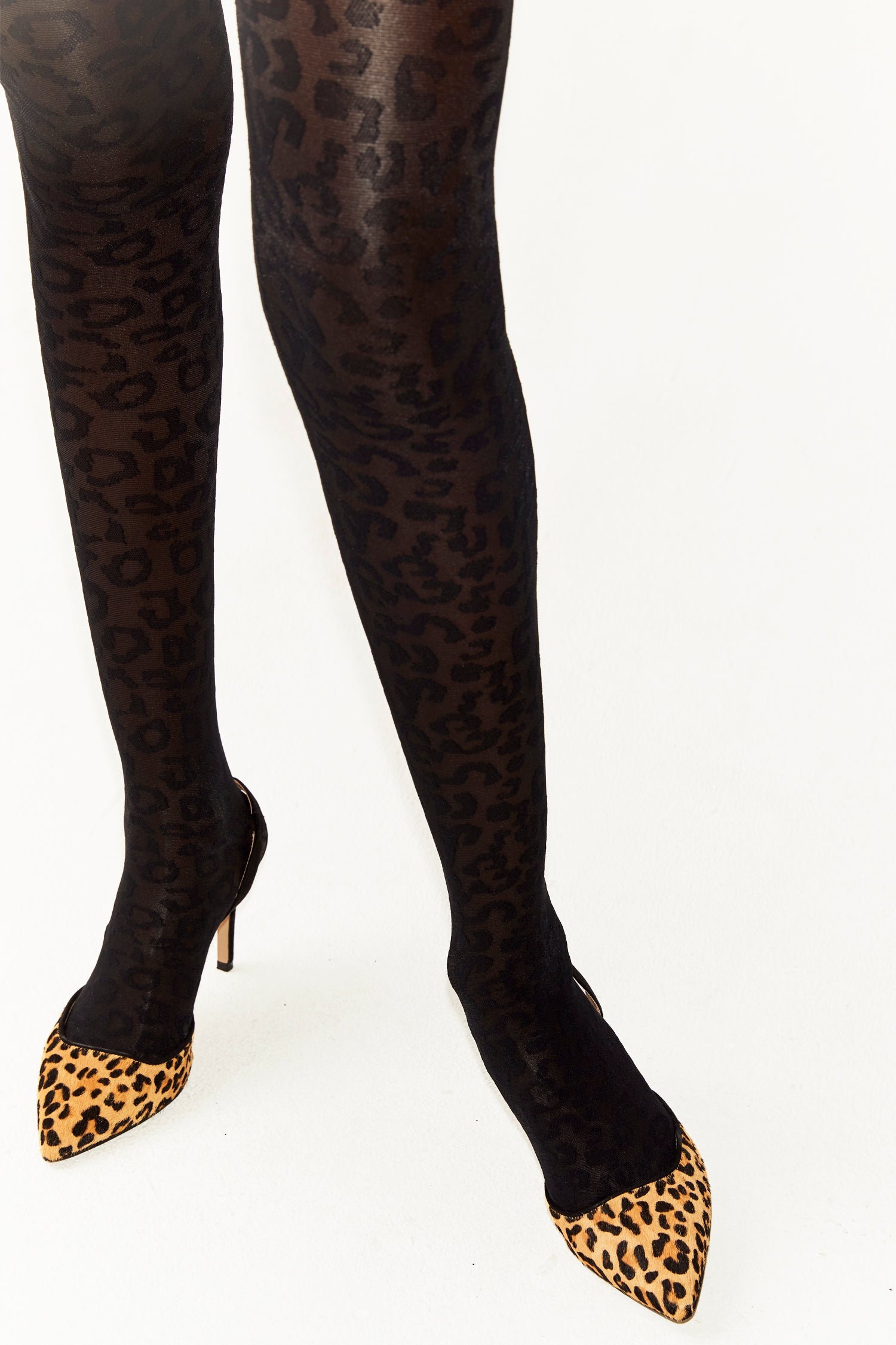 Model wearing Sheer Leopard Tights standing facing the camera close up