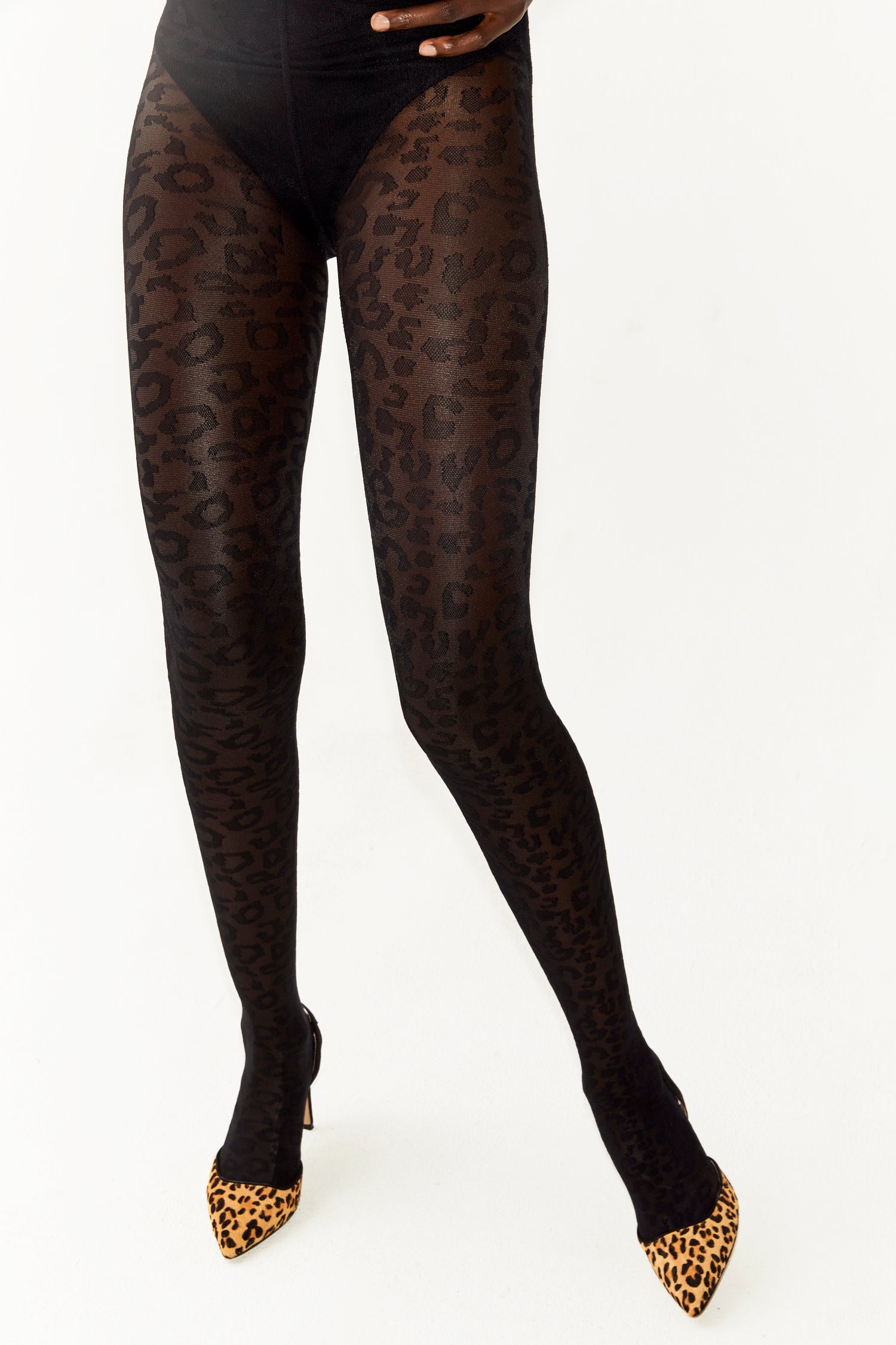 Model wearing Sheer Leopard Tights standing facing the camera 