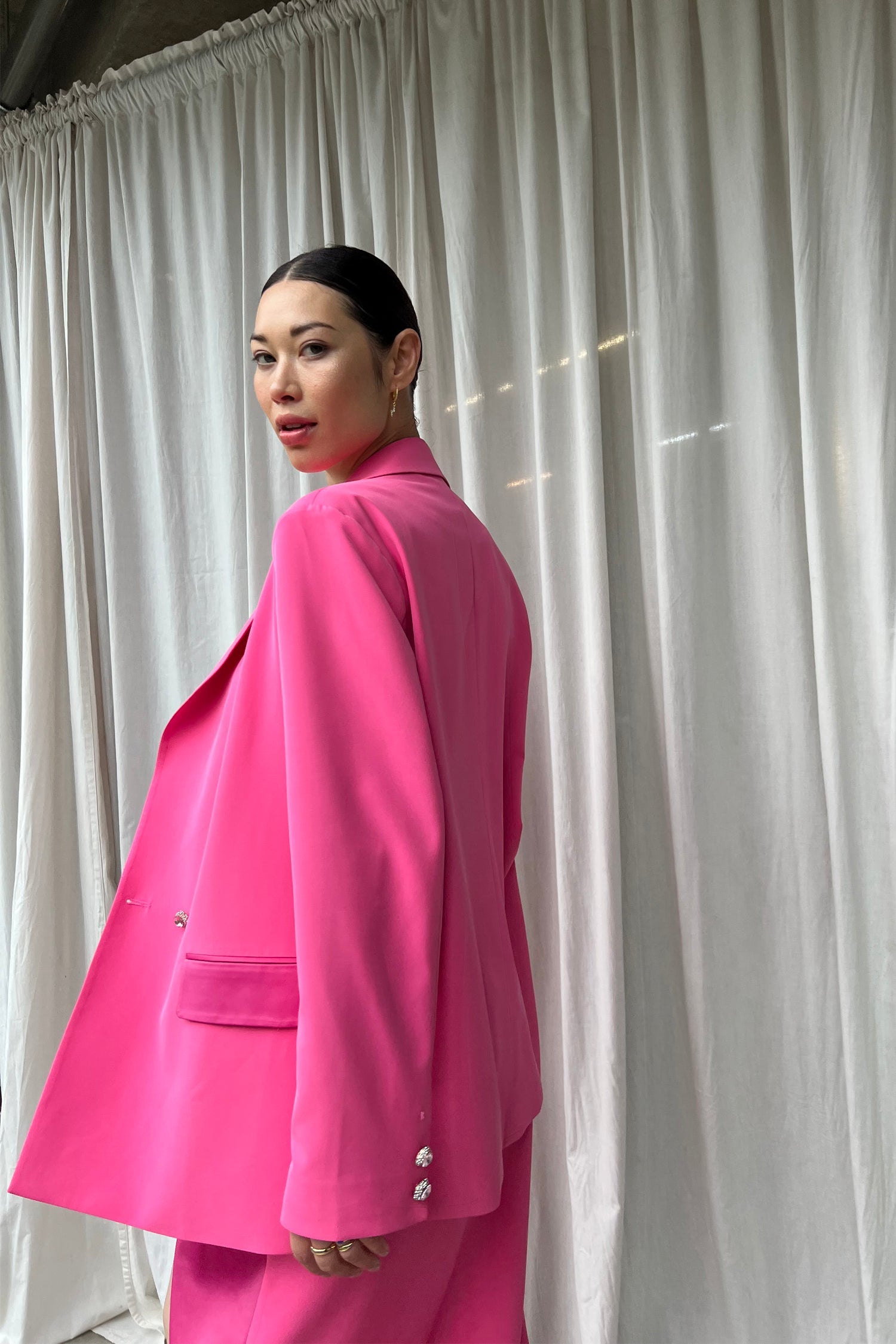 Model wearing Pink 54 Blazer standing facing away from the camera
