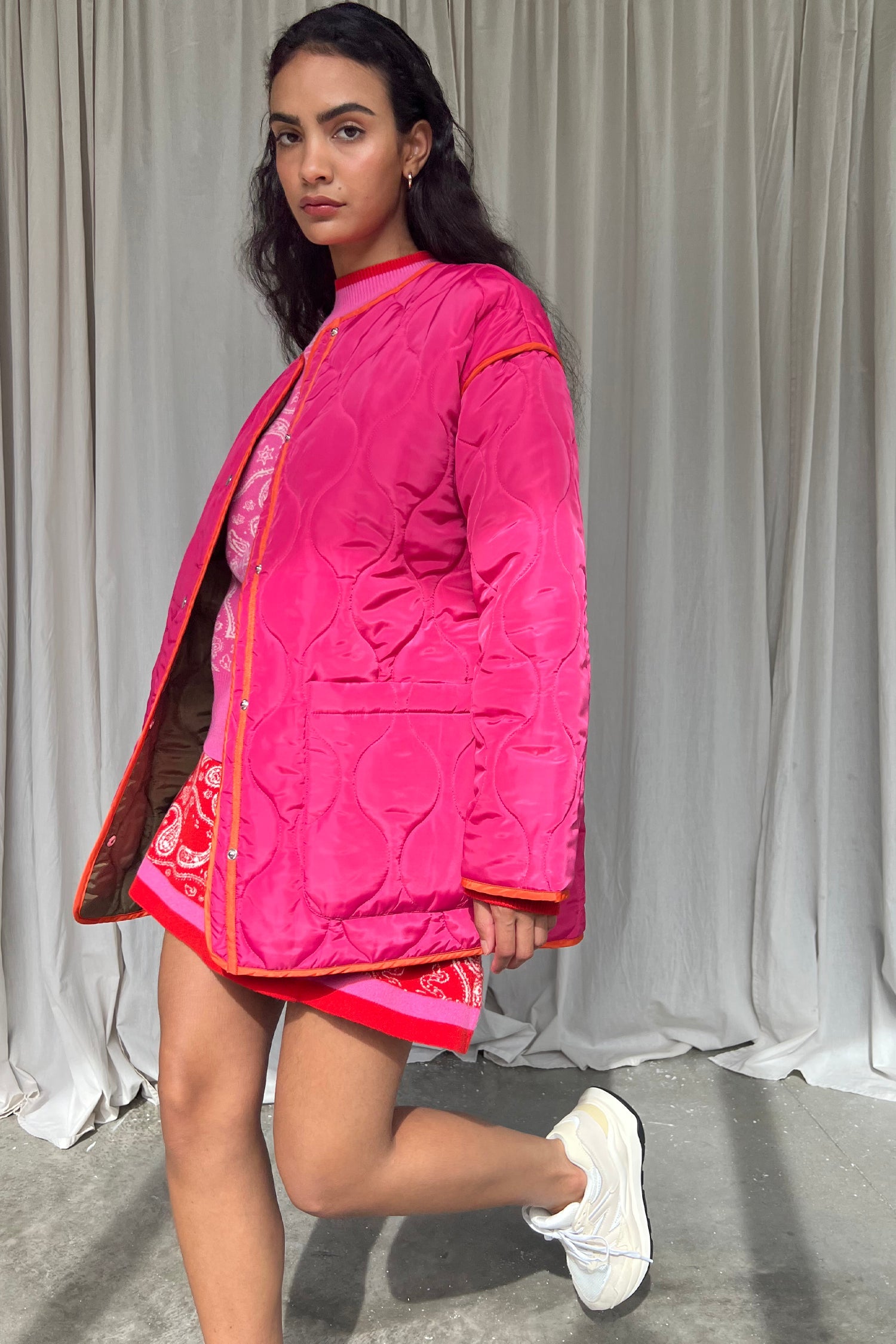 Model wearing Pink And Khaki Reversible Quilted Jacket standing facing the camera