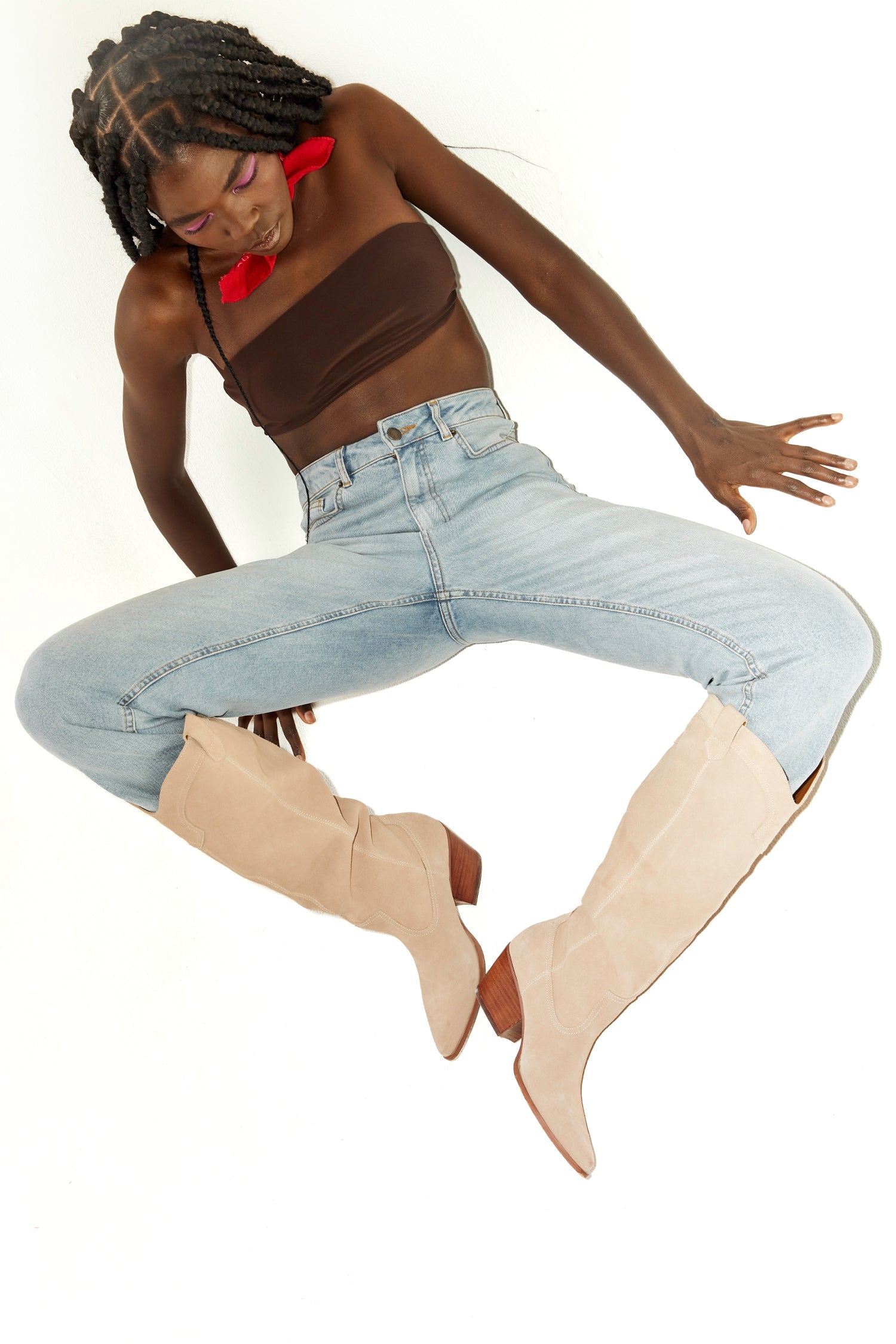 Model wearing Suede Cowboy Boot sitting