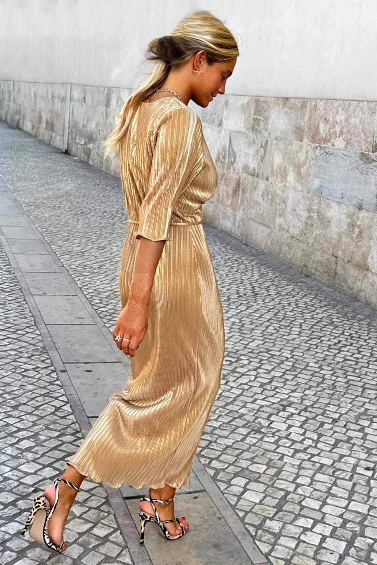 Model wearing gold plisse dress