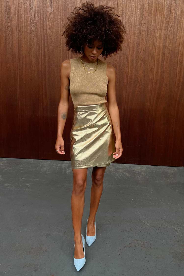 Model wearing Gold Vegan Leather Mini Wrap skirt