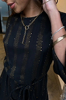 Thumbnail for Model wearing Black And Gold Riri Dress