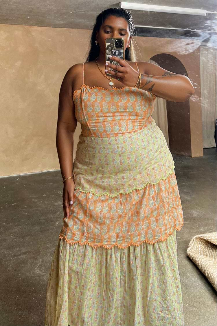 Model wearing Pink And Green Peony Dress facing the camera 