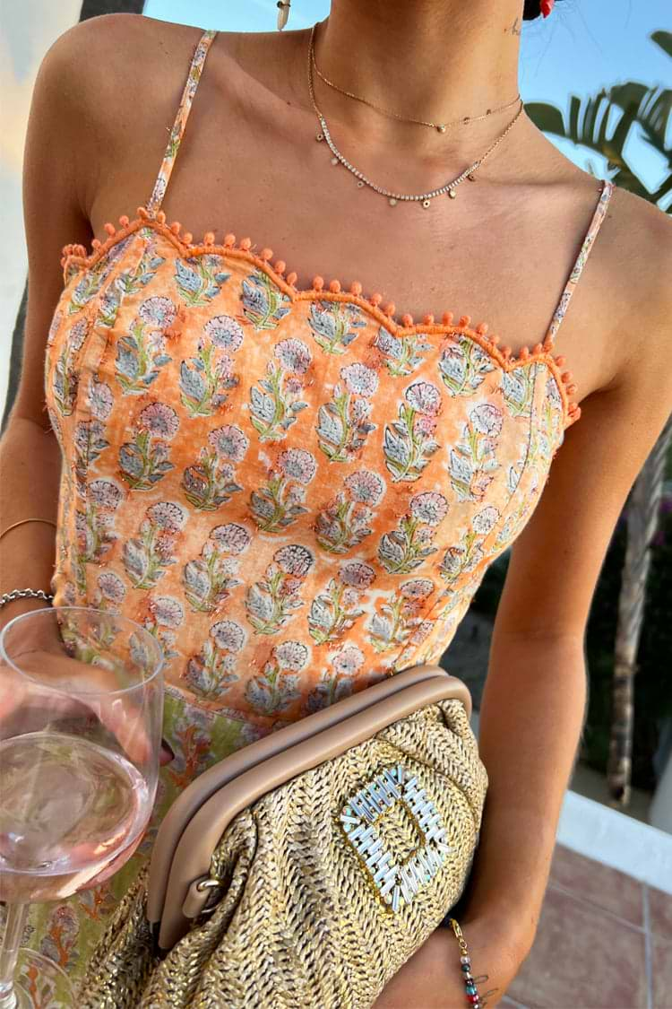 Model wearing Pink And Green Peony Dress facing the camera 