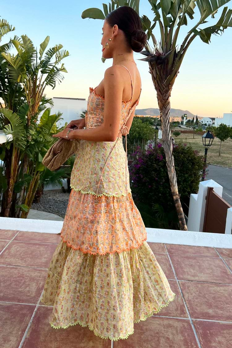 Model wearing Pink And Green Peony Dress facing away from the camera 