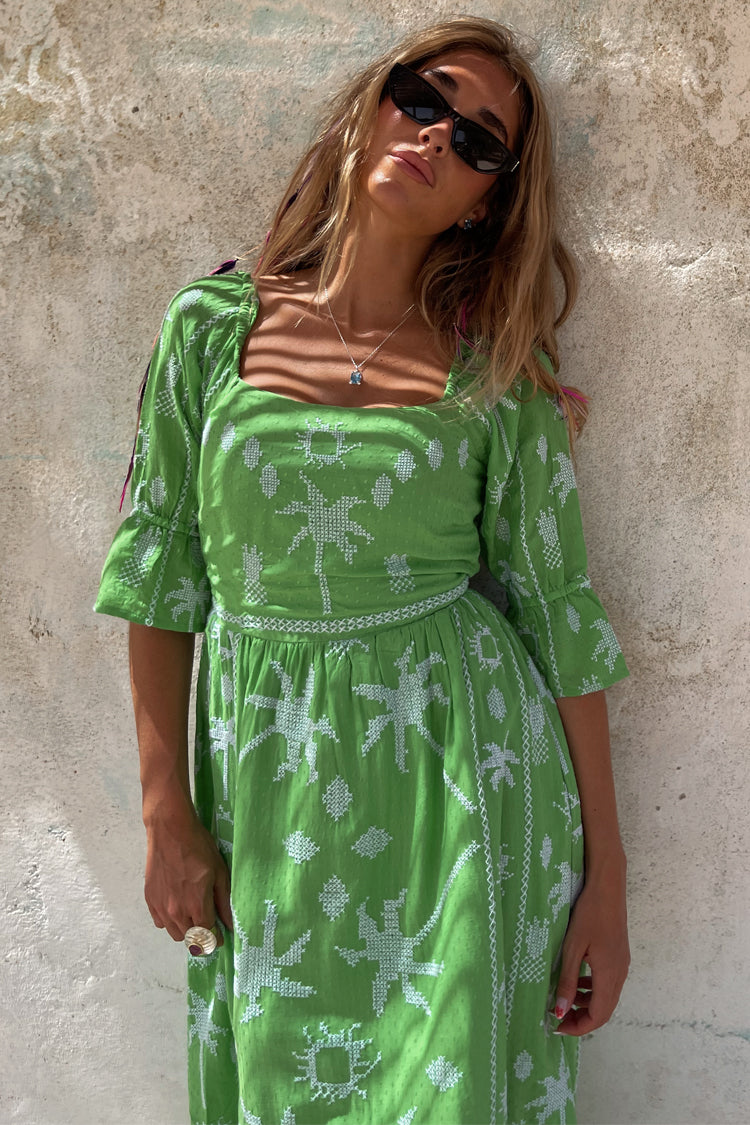 caption_Model wears Green Palm Cross Stitch Belle Dress in UK size 10/ US 6