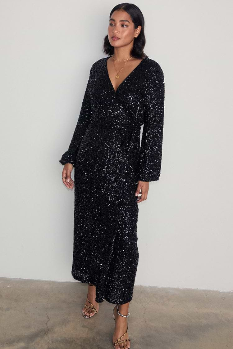 caption_Model wears Black Sequin Kira Wrap Dress in UK size 10/ US 6