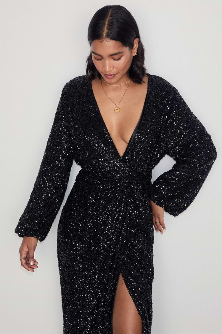 caption_Model wears Black Sequin Kira Wrap Dress in UK size 10/ US 6