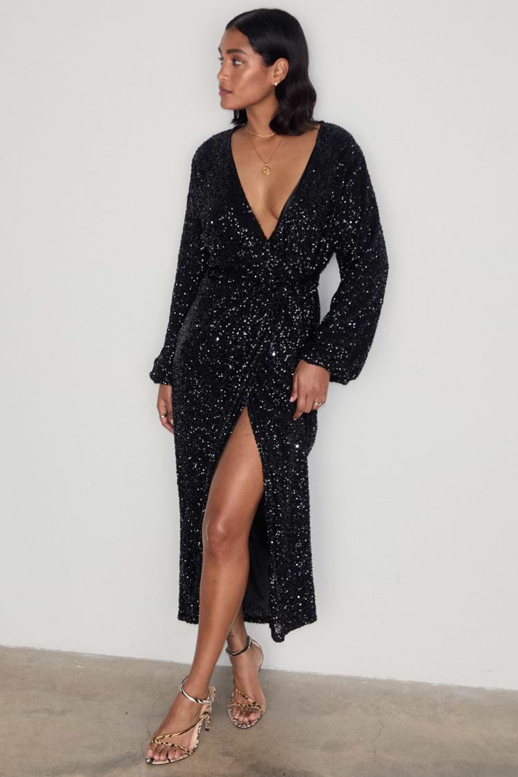 caption_Model wears Black Sequin Kira Wrap Dress in UK size 10/ US 6