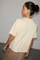 Thumbnail for caption_Model wears Cream Beaded Logo T-shirt in size M