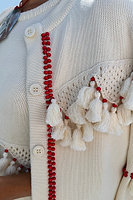Thumbnail for caption_Model wears Ivory and Red Harper Cardigan in size S