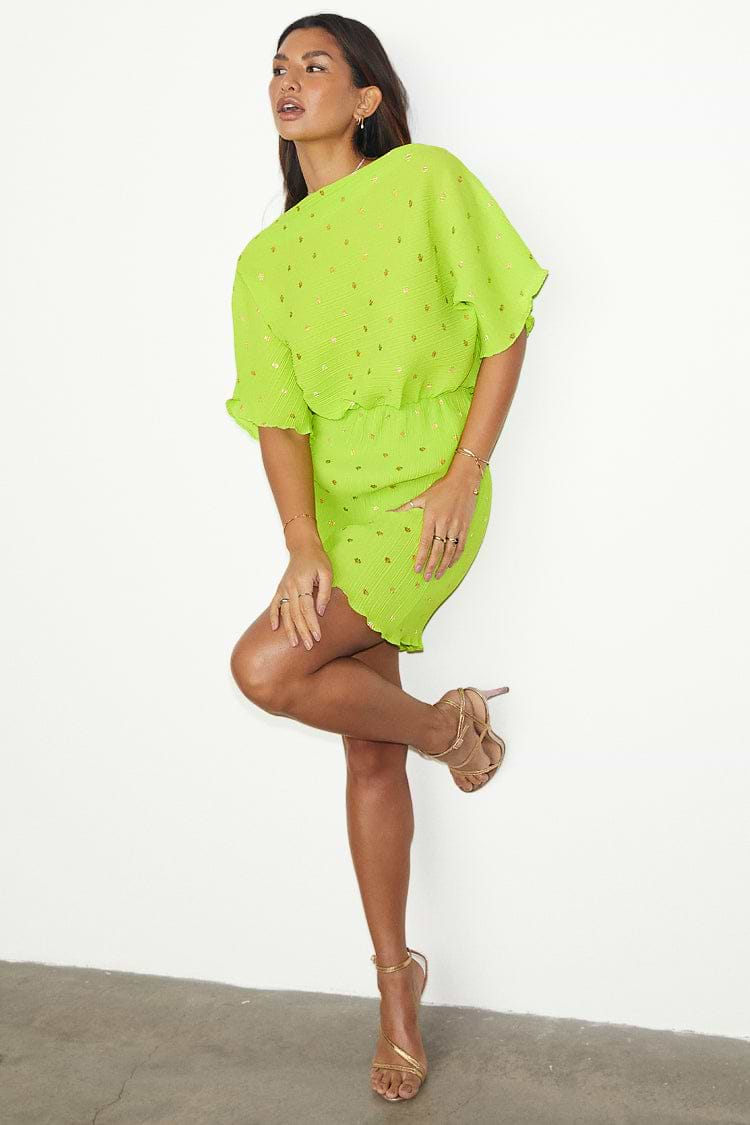 caption_Model wears Lime Plisse Mini Tilly Dress in UK size 10/ US 6