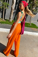 Thumbnail for caption_Model wears Orange Demi Cotton Linen Trousers in UK size 10/ US 6
