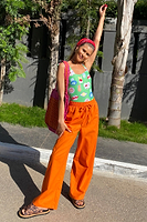 Thumbnail for caption_Model wears Orange Demi Cotton Linen Trousers in UK size 10/ US 6