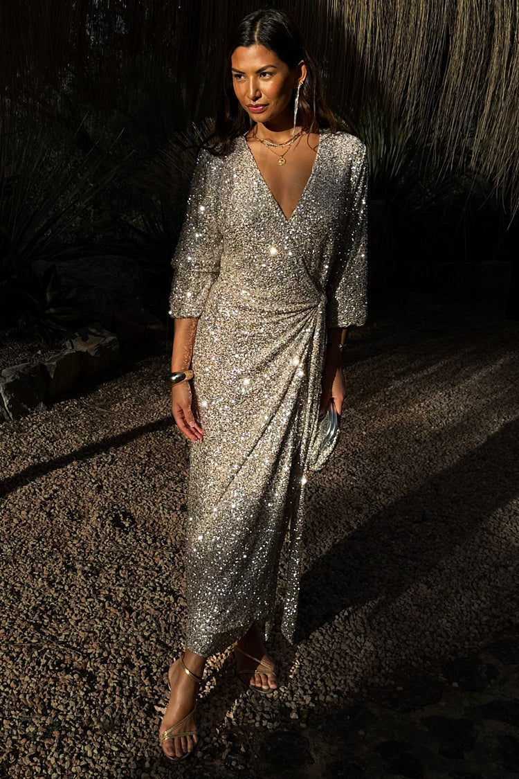 caption_Model wears Silver Sequin Kira Wrap Dress in UK size 8/ US 4