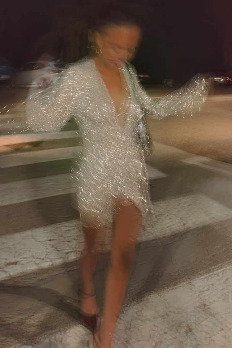 caption_Model wears Silver Sequin Mini Vienna Wrap Dress in UK size 10/ US 6