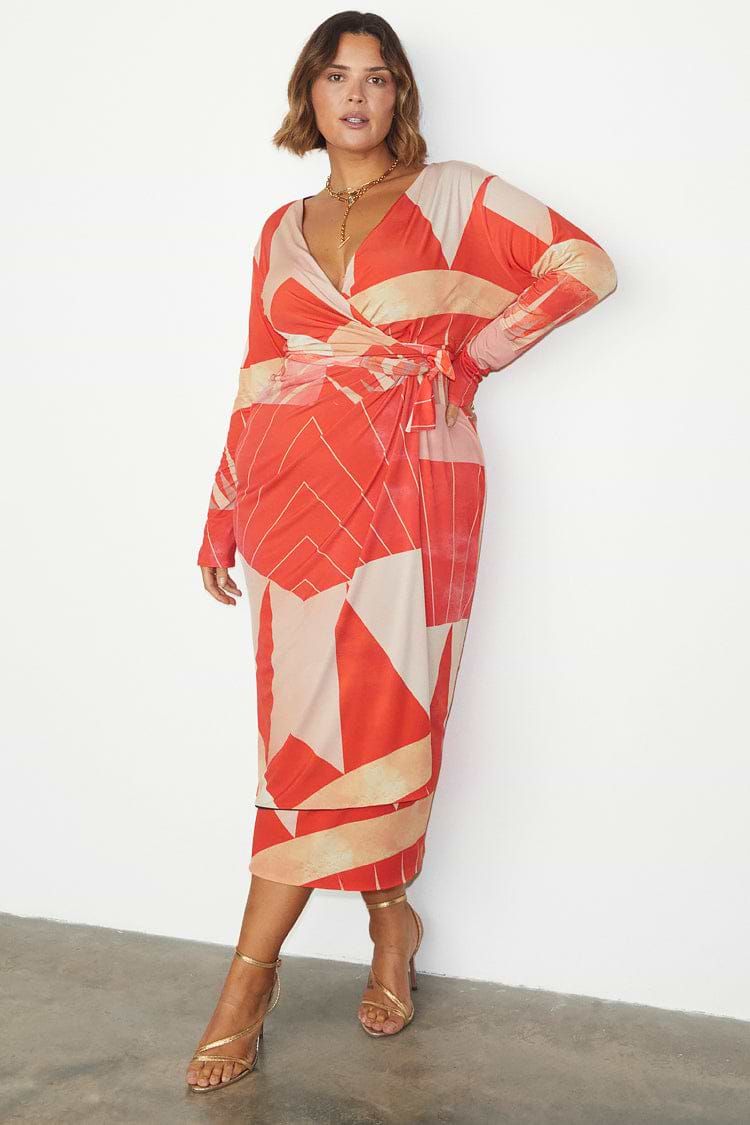 caption_Model wears Reversible Sundial Wrap Dress in UK size 18 / US 14