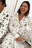 Thumbnail for caption_Model wears Cream Tattoo Button Through Pyjamas in UK size 18/ US 14