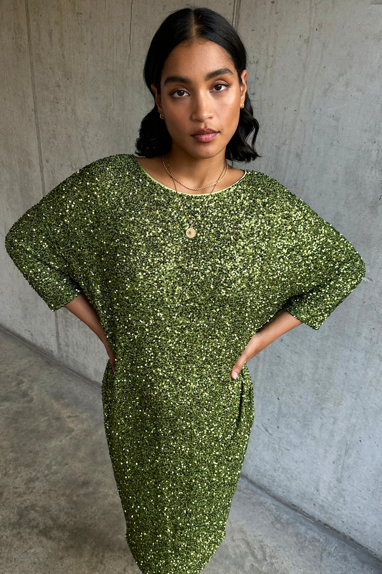 caption_Model wears Olive Sequin Jem Dress in UK size S/M