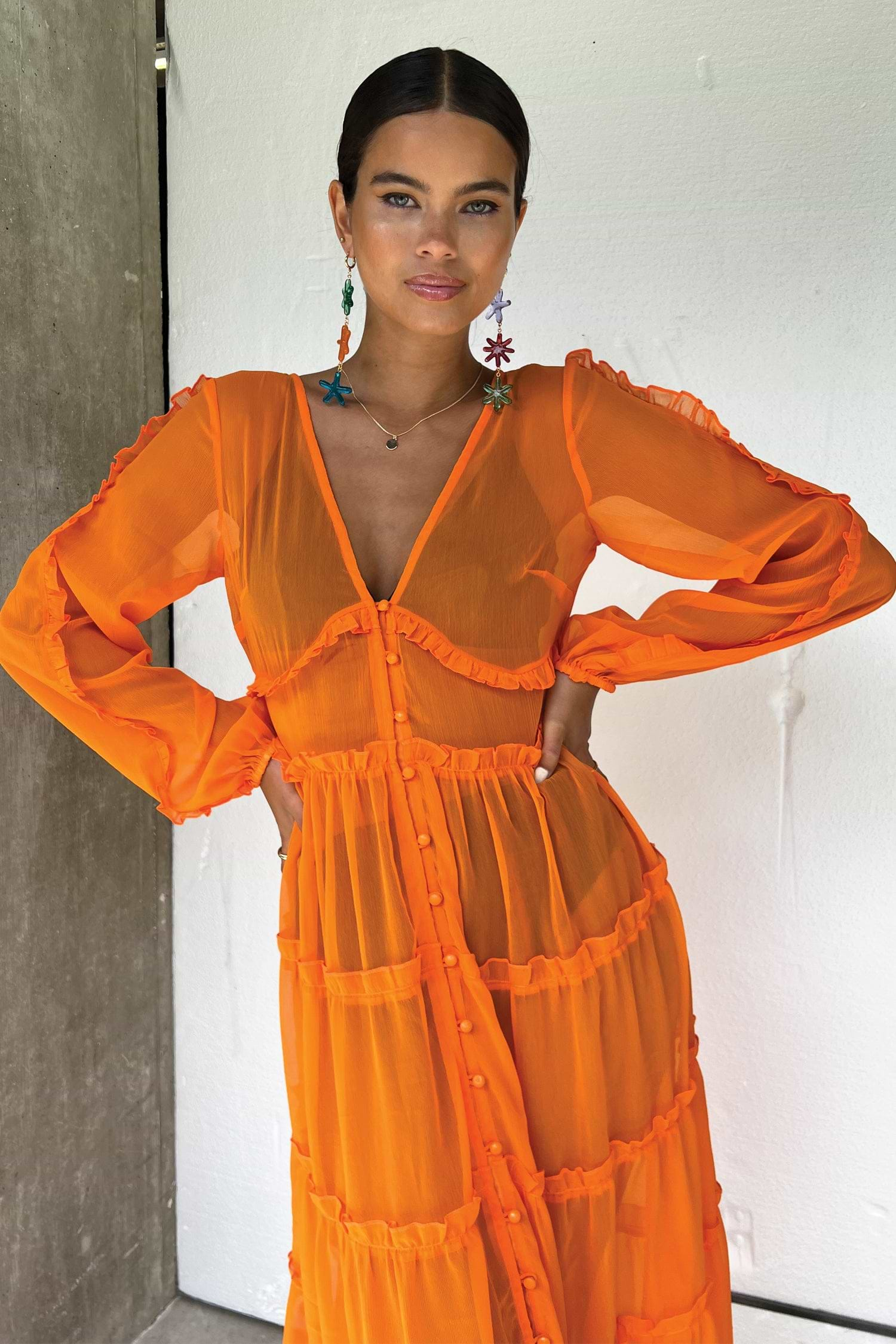 Model wearing Orange Clemmie Dress facing the camera